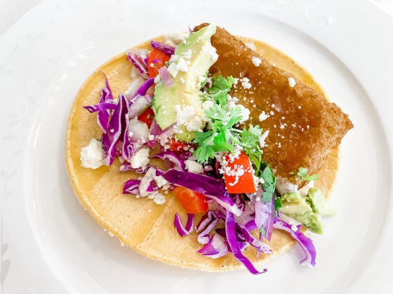 The best fish tacos served on a white dish