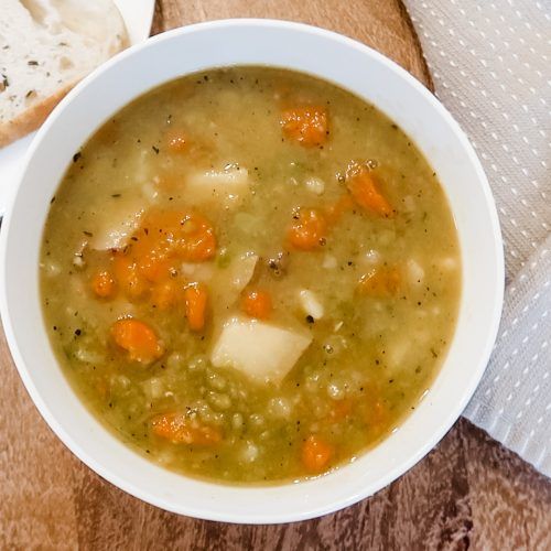 split pea soup with potatoes served with a homemade slice of bread
